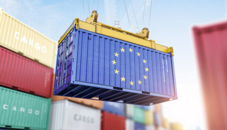Cargo shipping container with EU European Union flag in a port harbor. Production, delivery, shipping and freight transportation of EU products concept.
